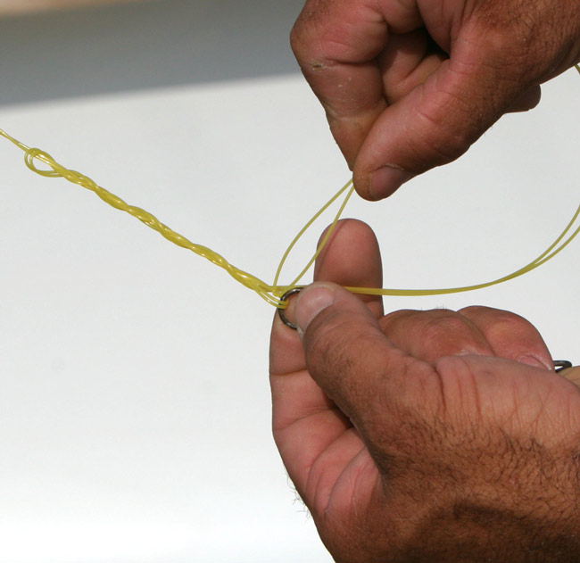 Next, take the double line tag end and insert it through the small gap (just like a fisherman knot) as pictured