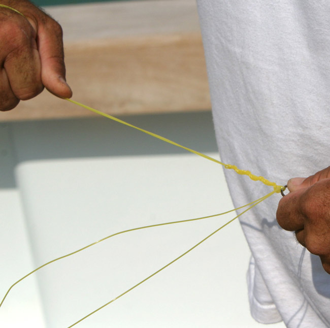 Next, moisten the entire knot and pull from the main line and swivel