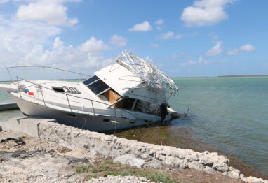 boat run aground on beach damaged from a hurricane