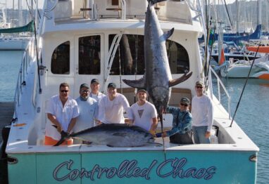 crew with marlin on boat