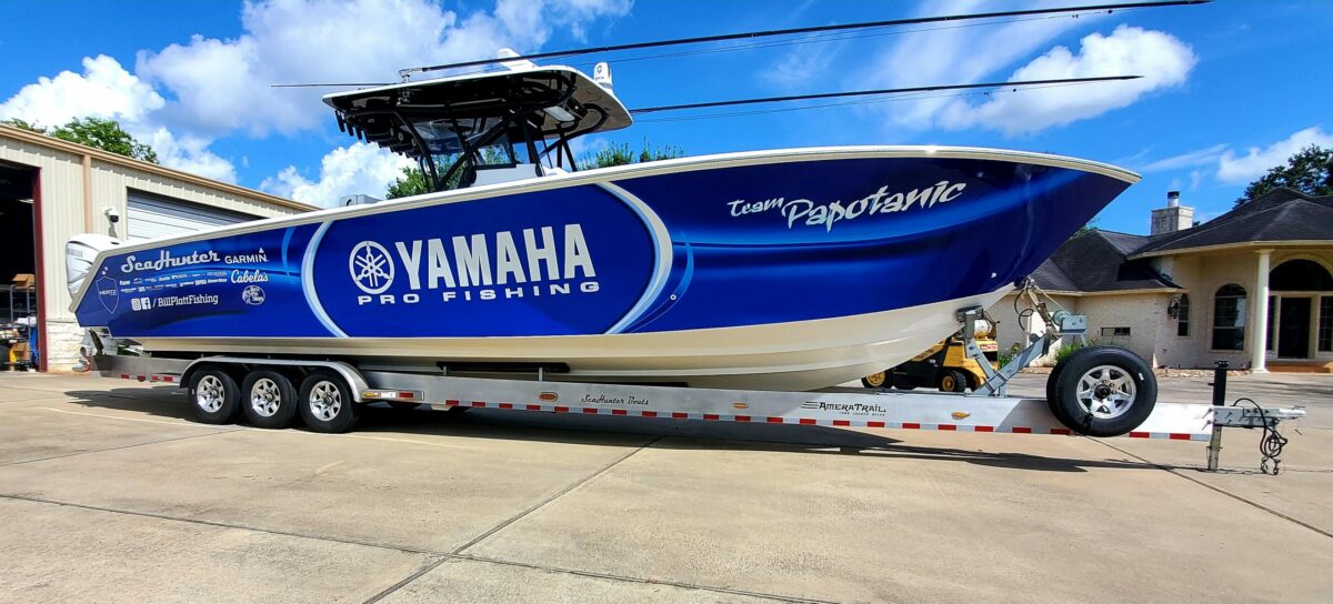 A Yamaha Pro Fishing yacht resting on land.
