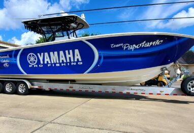 A Yamaha Pro Fishing yacht resting on land.