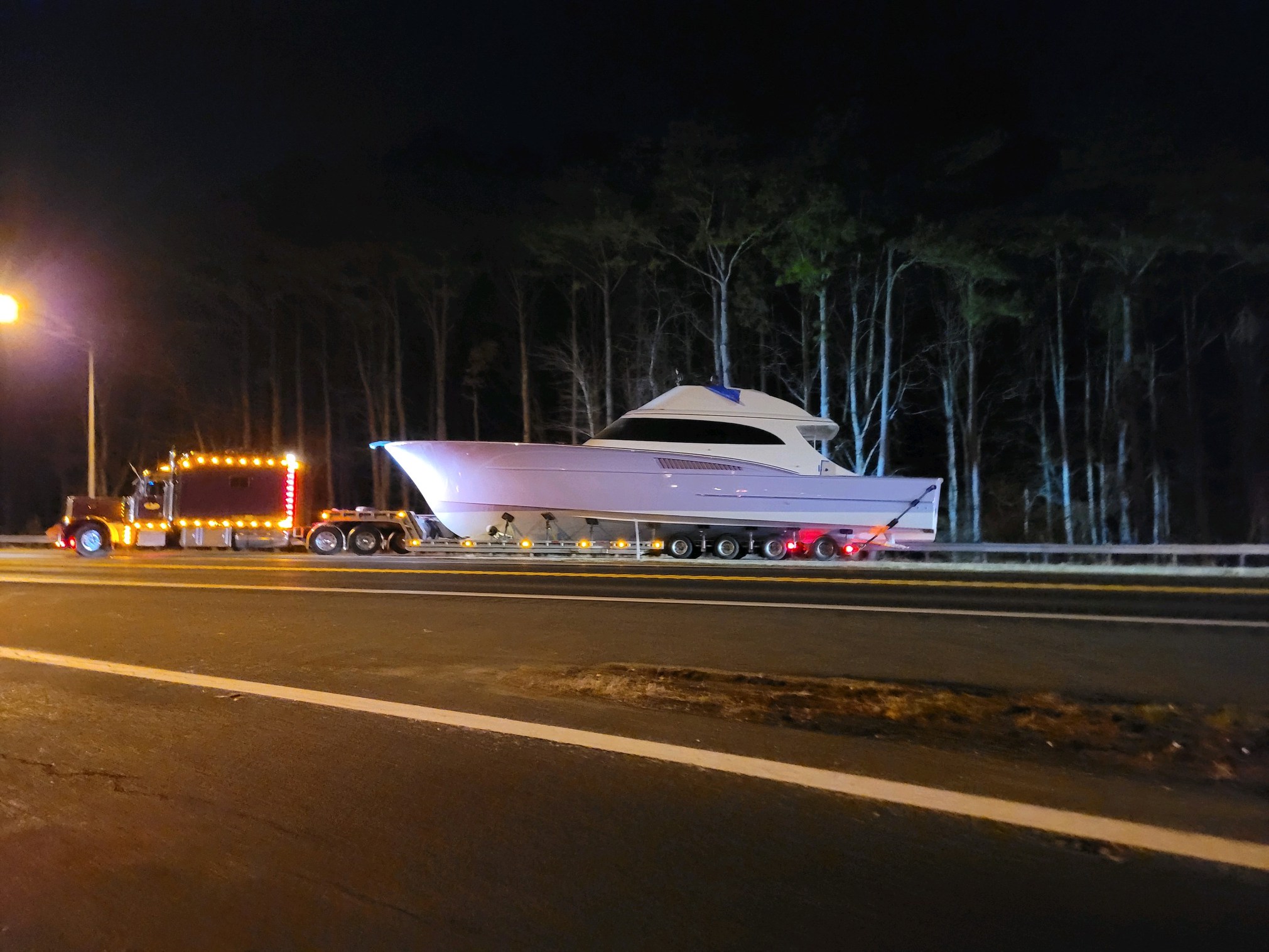 The Lunatico being towed on the road at night.