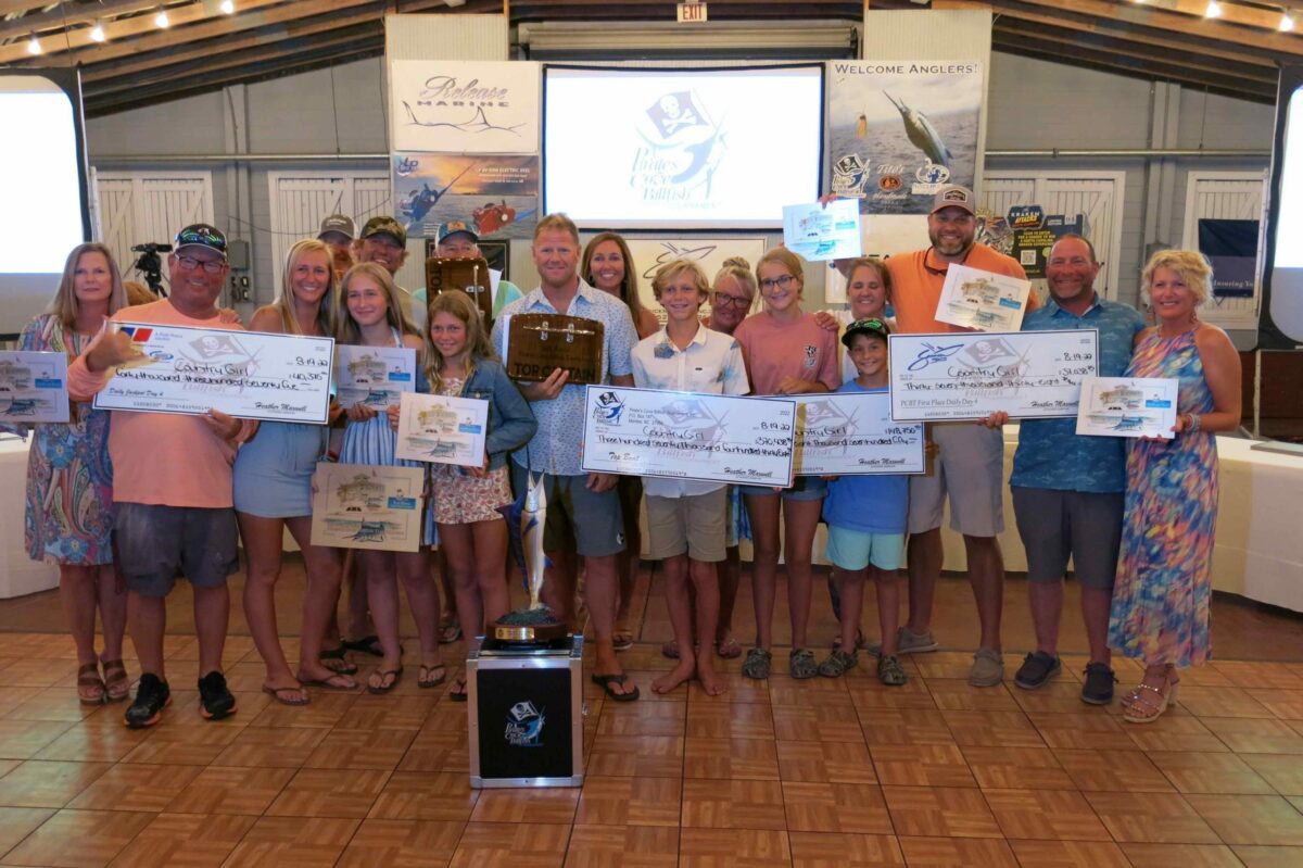 The crew of the Country Girl posing with a check for their prize money.