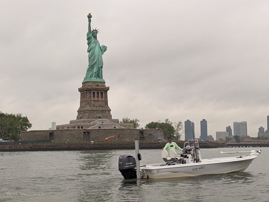 Capt. Frank fishing by the Statue of Liberty.