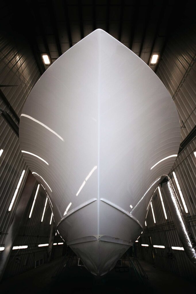 A beautifully faired hull awaits her topcoats. Photo: Bayliss Boatworks