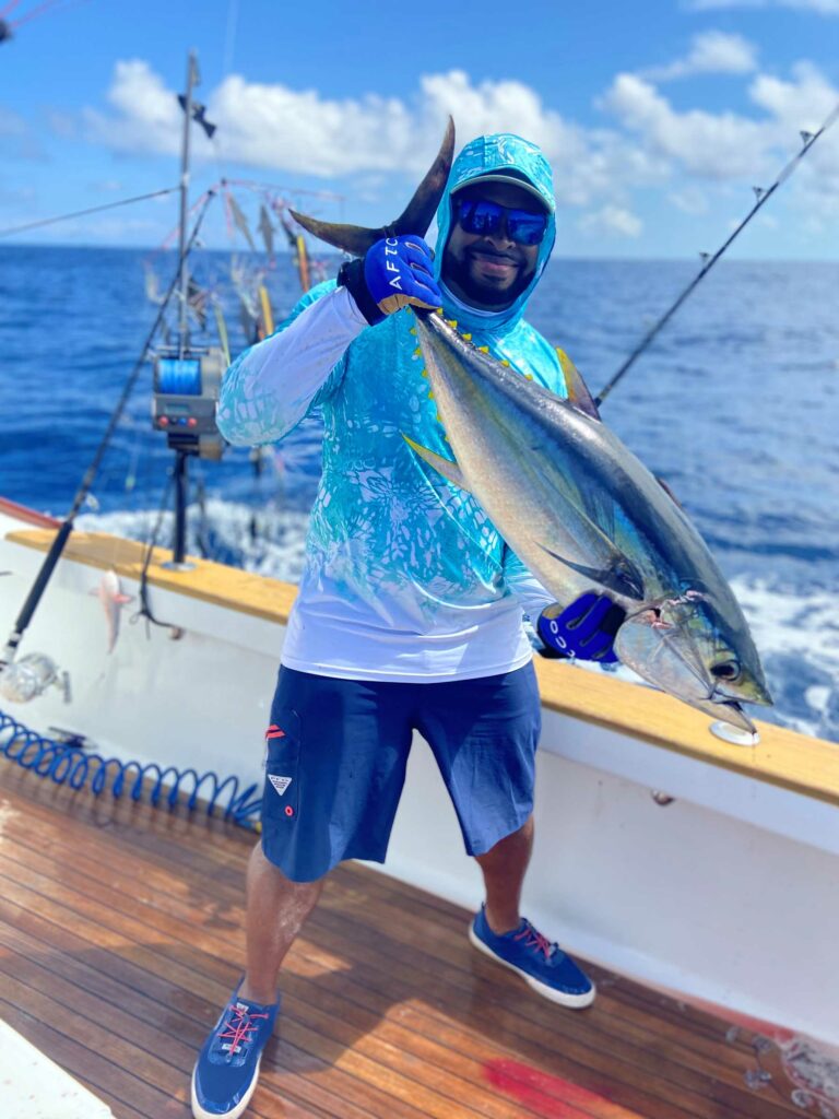 Photo of a man holding a tuna