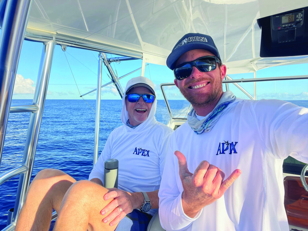 Hawaii Sportfishing Dean Lemman, owner of the champion vessel Apex, and seasoned Capt. Cyrus Widhalm, share a moment of anticipation as they keenly await the day's first big bite off the coast of Hawaii.