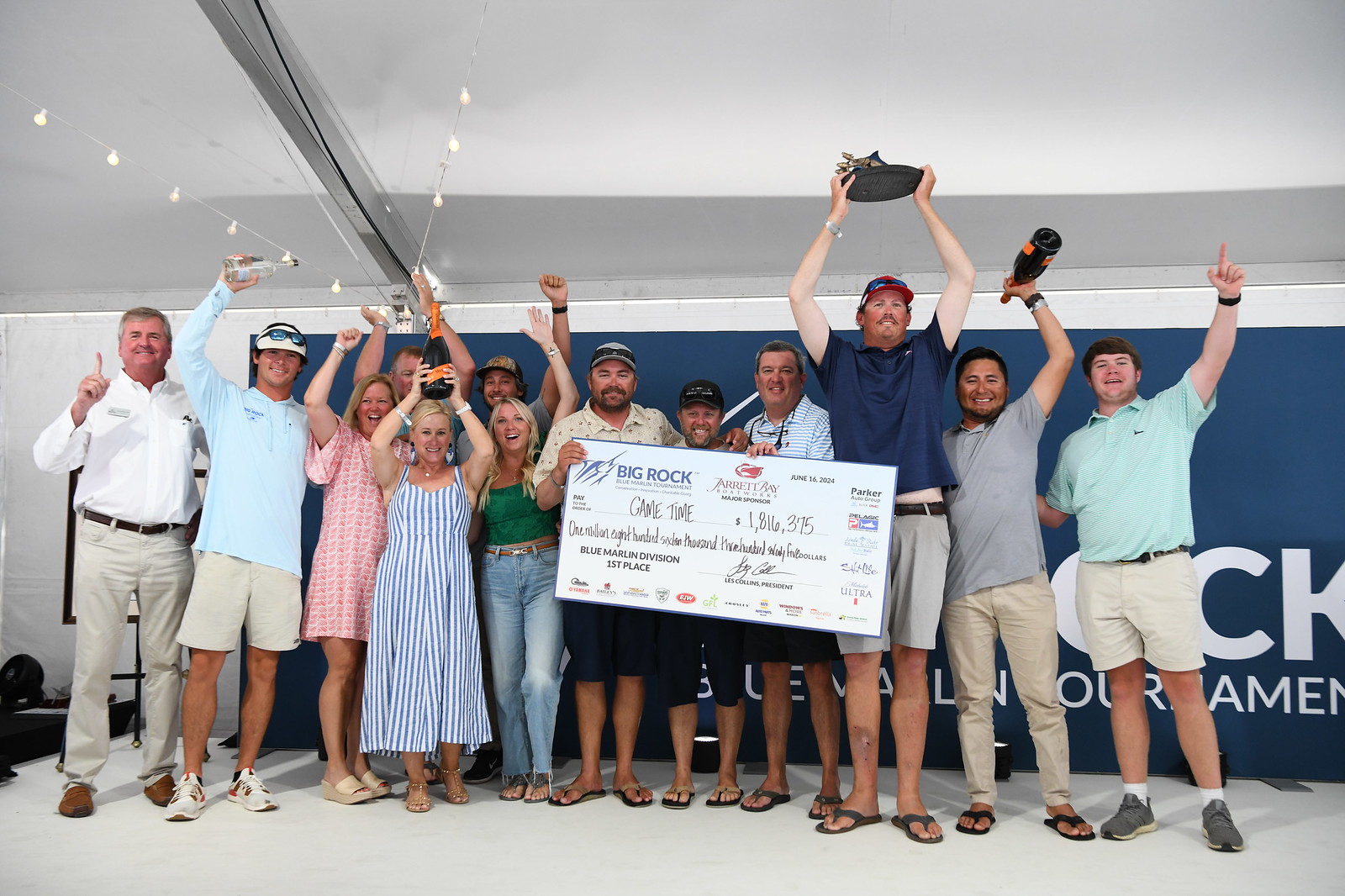 Game Time team holding a check