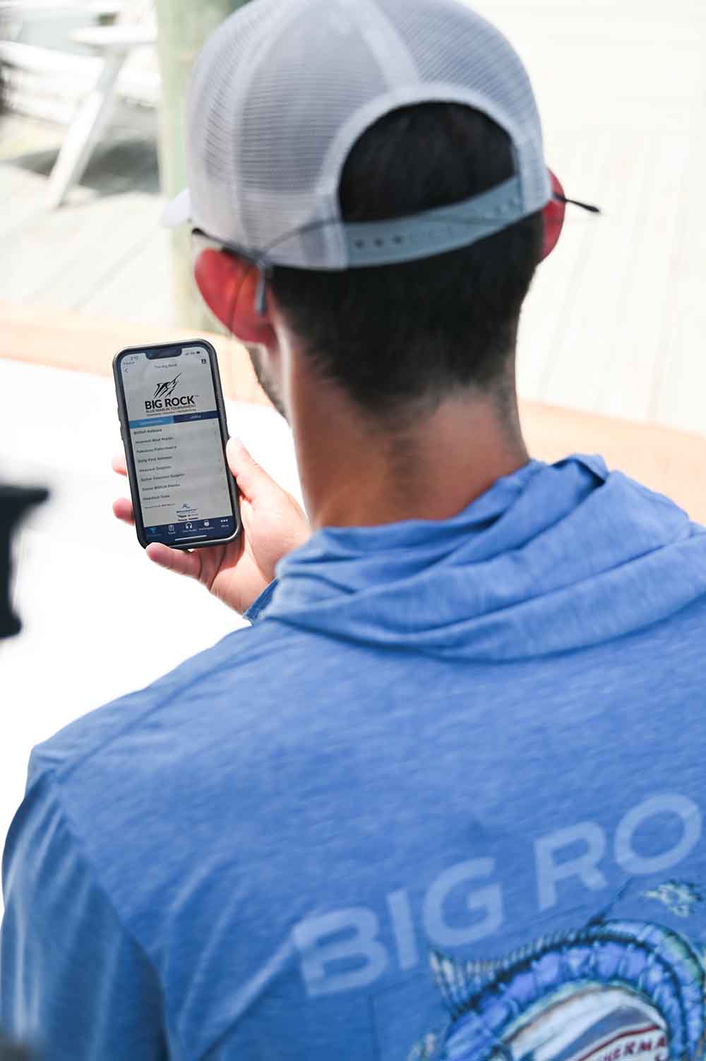 a guy looking at tournament scoreboard on his phone
