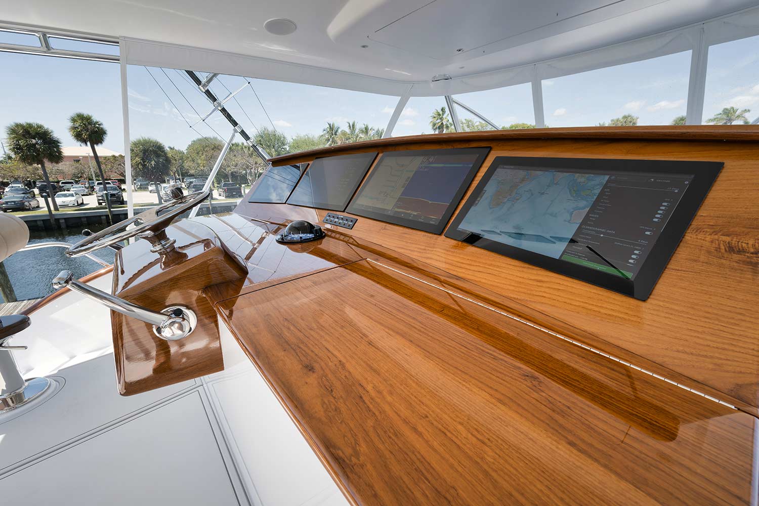 Merritt Boatworks 77 helm dashboard showing the sterring wheel and electronic screens