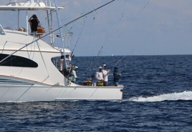 Boat ownership can be rewarding as you see a bunch of friends fishing on a boat in this image