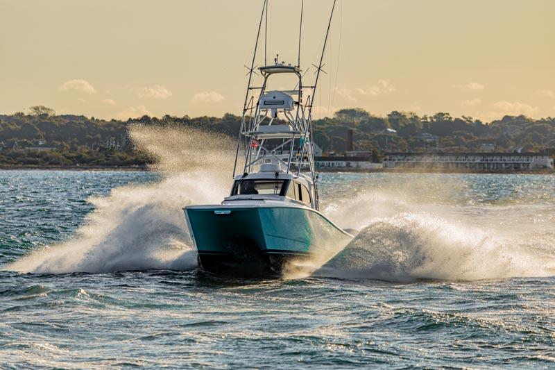 catamaran boat running with spray showering from both sides of the boat