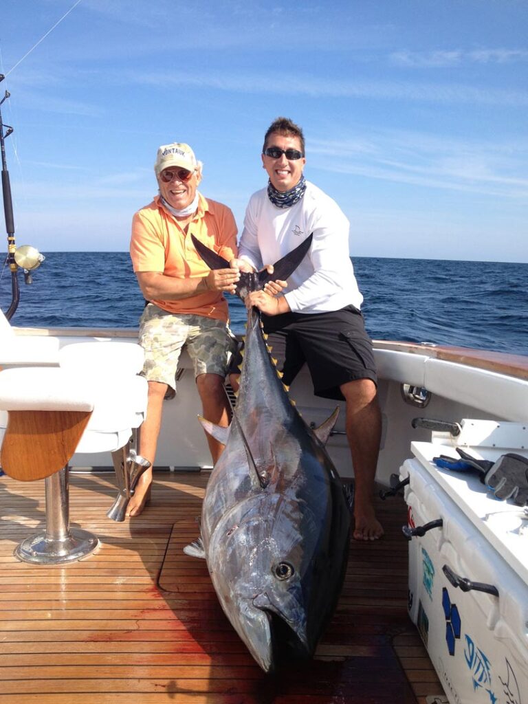 Jimmy Buffett left and captain Vinnie Lasorsa right holding a nice bluefin tuna as the back of the boat