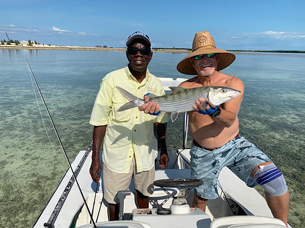jimmy buffett and his guide holding up a nice bahamas bonefish