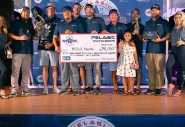 winning team on stage with a big check in Costa Rica