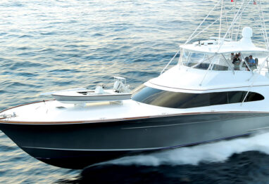 grey and white sportfishing boat running on the ocean