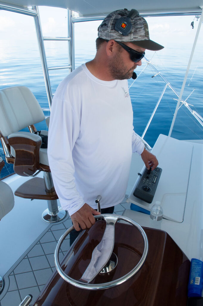 a sportfishing captain looking at his sonar screen
