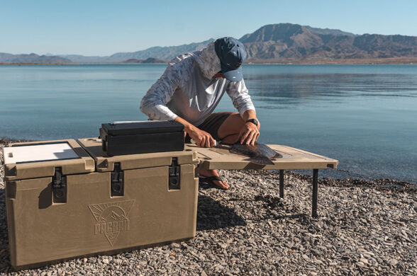 pacbak p88-mk cooler brown in color with a guy filleting fish next to it
