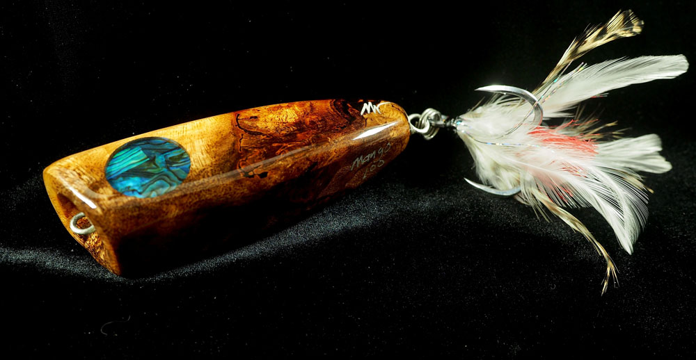 a golden lure with feathers