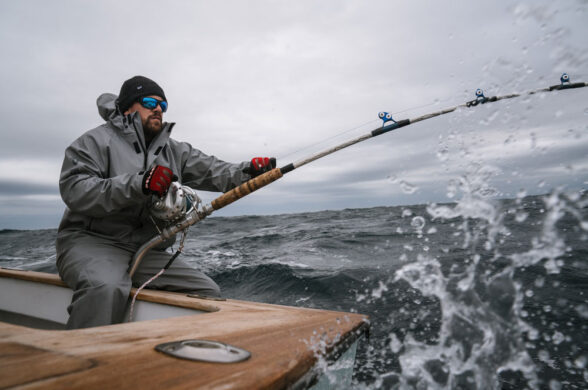 a guy fishing wearing pelagic foul weather gear offshore fishing