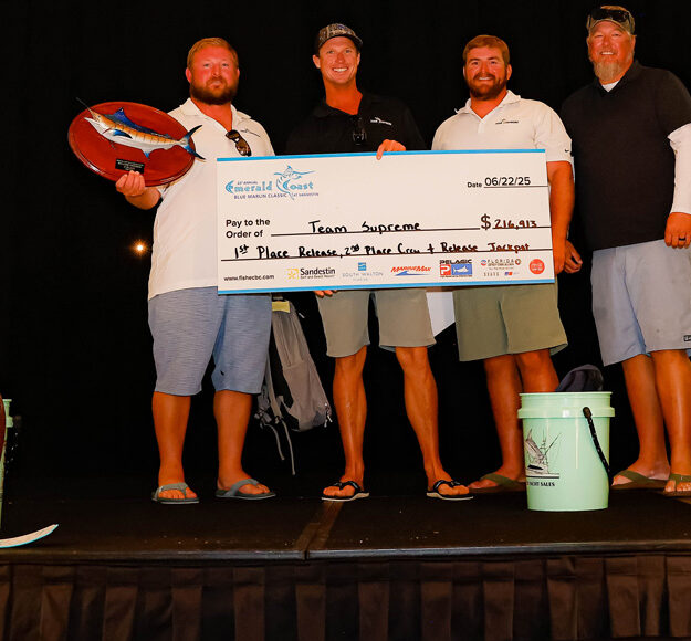 team supreme with a winning tournament check during the award ceremony