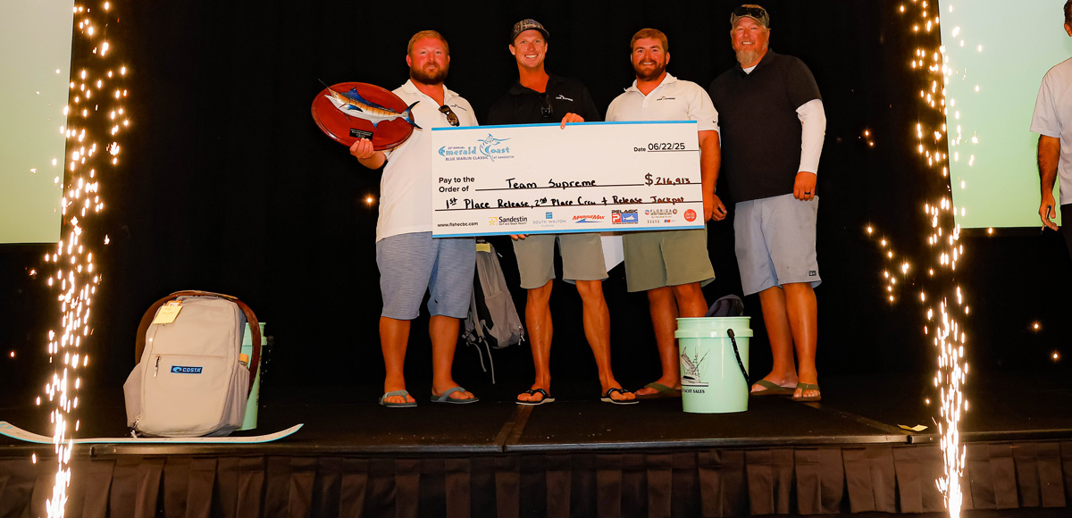 team supreme with a winning tournament check during the award ceremony