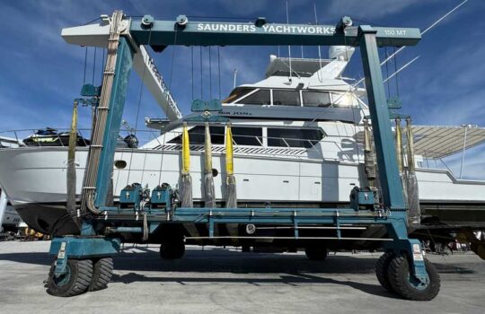 depicts a big sportfishing boat in a travel lift for the article REFIT GUIDE: WHEN DOES MAINTENANCE BECOME A REFIT?