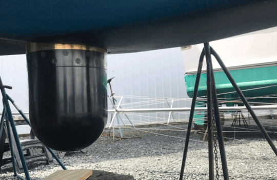 a boat sonar extended from the bottom of the boat on land