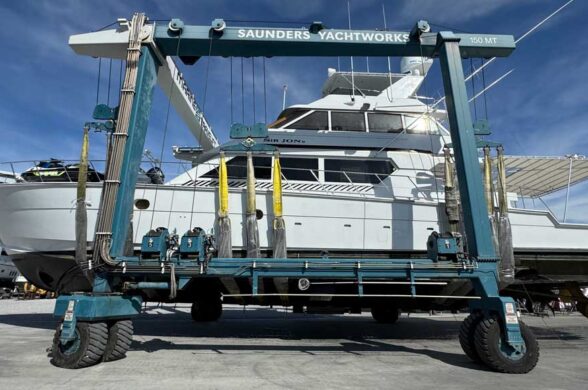 depicts a big sportfishing boat in a travel lift for the article REFIT GUIDE: WHEN DOES MAINTENANCE BECOME A REFIT?