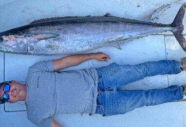 Northeast Florida Wahoo Fishing has emerged as a place for giant wahoo like this one with a man lying next to it