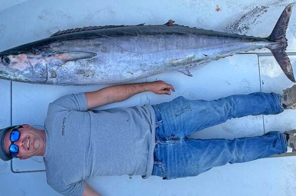 Northeast Florida Wahoo Fishing has emerged as a place for giant wahoo like this one with a man lying next to it