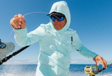AFTCO’s Air-O Mesh Performance Collection on a guy holding a fishing line
