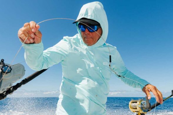 AFTCO’s Air-O Mesh Performance Collection on a guy holding a fishing line
