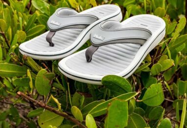 Huk Launches Rogue Island Flip Flop sitting on a green bush