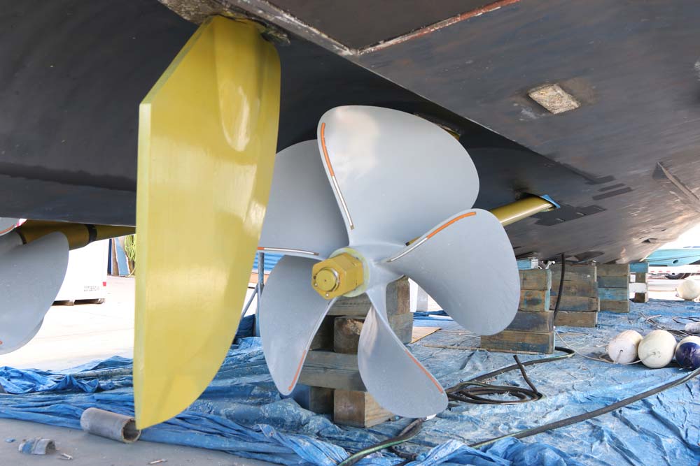 a gold rudder behind a grey propeller