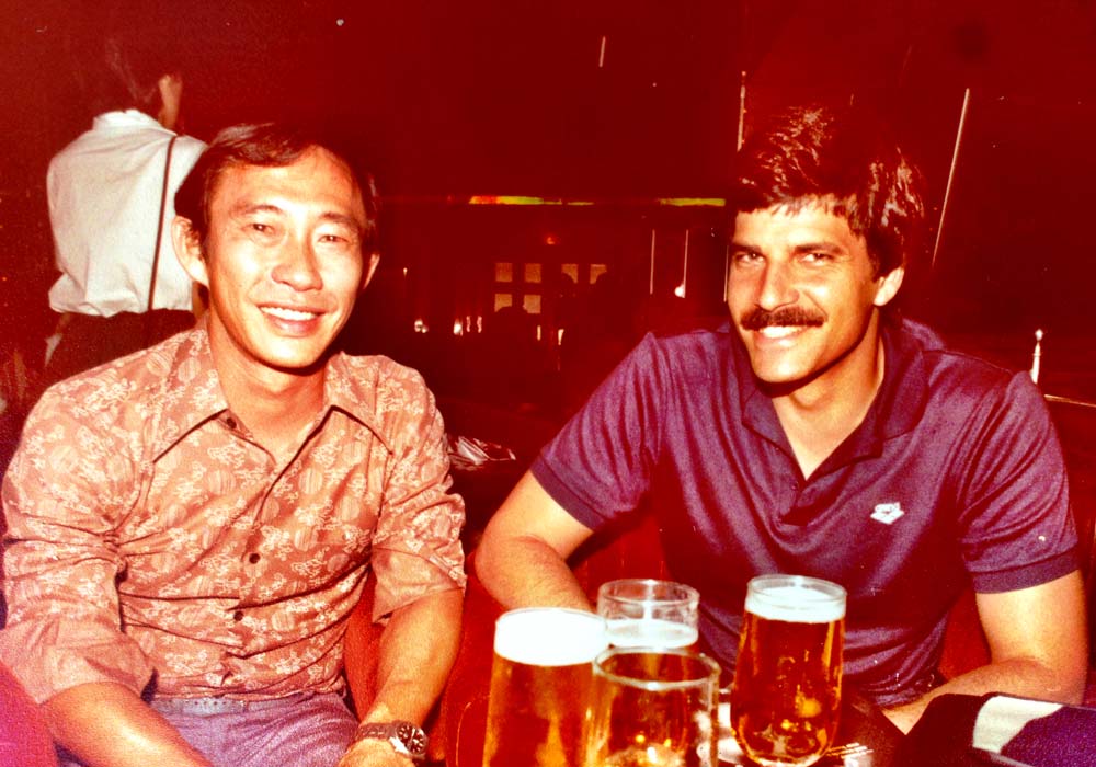 John Lau, Famous South Pacific Lure Maker next to a guy in a blue shirt