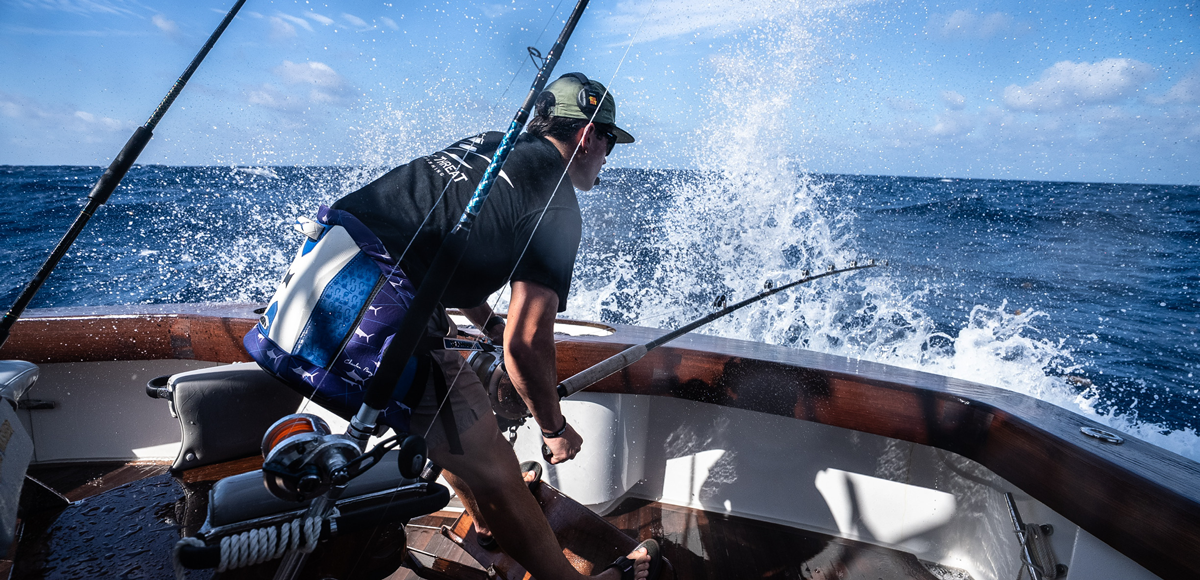 angler fishgting a blue marlin in rough seas