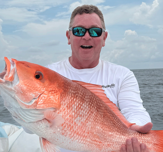 Jeff angers holding up a red snapper