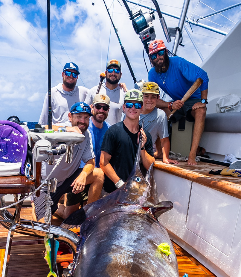 the crew of metal masher with a blue marlin in the boat
