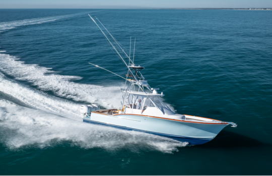 triple poutboard sportfishing boat running on the ocean make a gradual turn