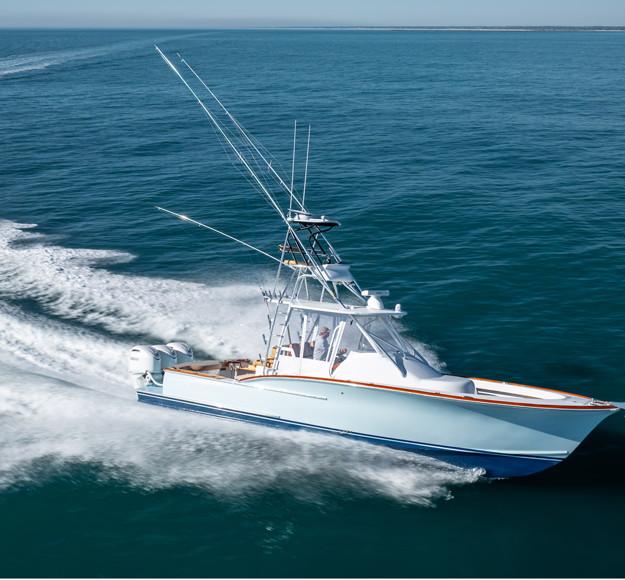 triple poutboard sportfishing boat running on the ocean make a gradual turn