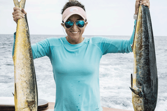 Carly Hysell from Garmin holding up two mahi