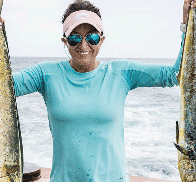 Carly Hysell from Garmin holding up two mahi