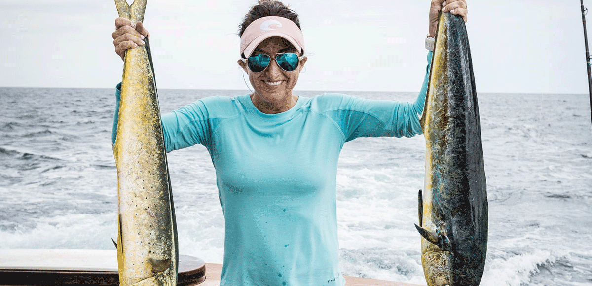 Carly Hysell from Garmin holding up two mahi