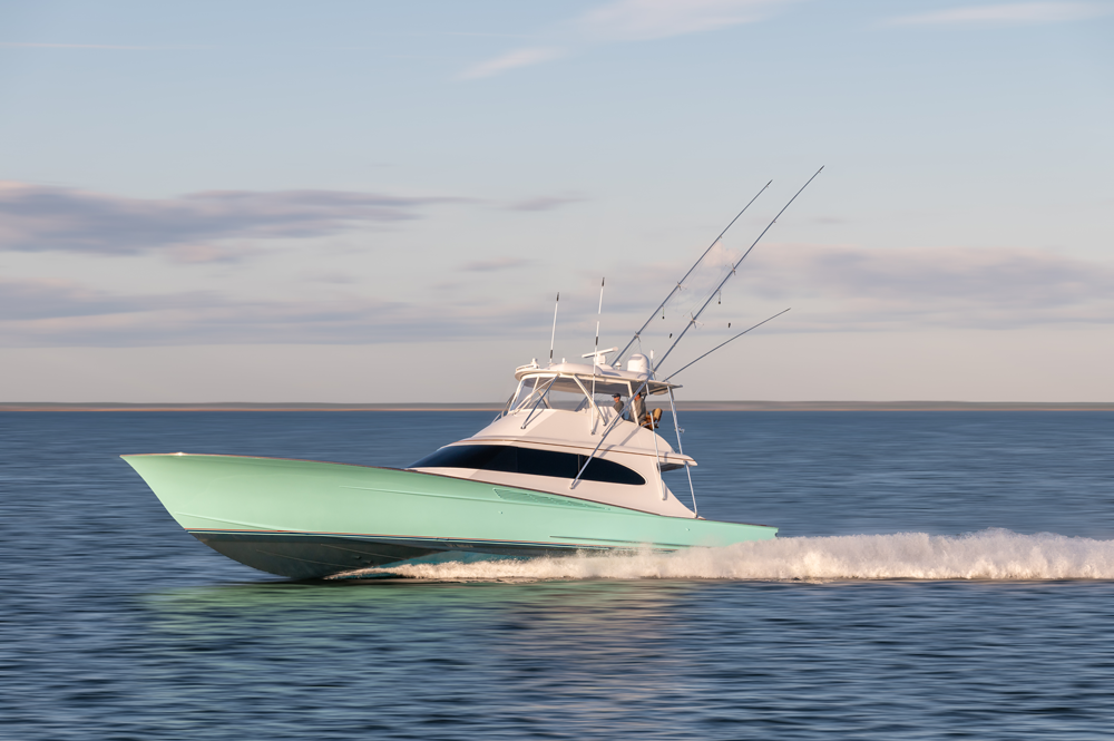 side profile of a sportfishing boat running on the open ocean in green color