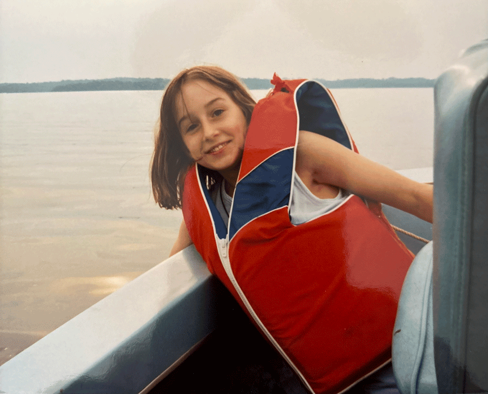 Carly Hysell from Garmin on a boat in a life jacket at a young age