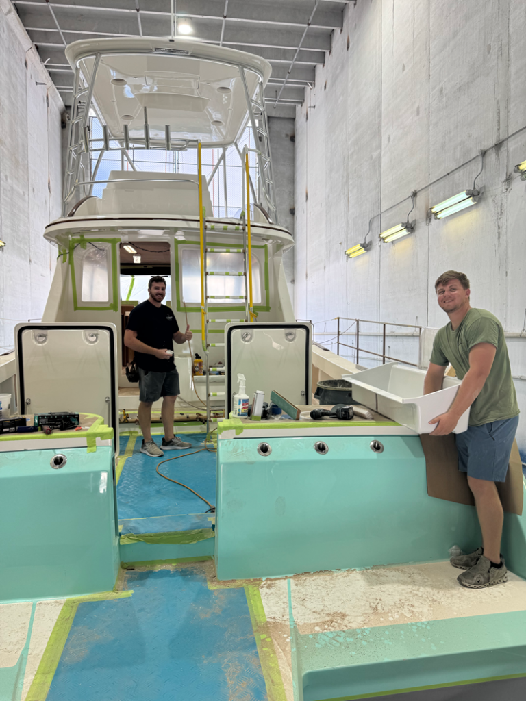 2 workers on the 56' Merritt Catamaran
