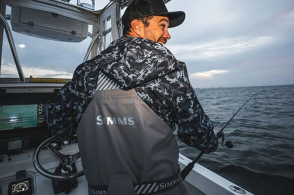 a captain wearing Simms Rip Line Pro on grey