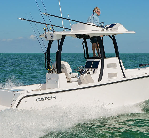 Catch boat running on the ocean with a mercury outboard